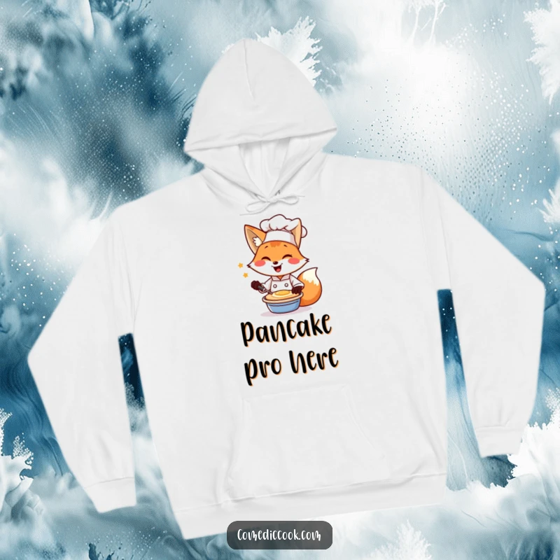 Funny hoodie showcasing a smiling fox chef winking as he flips a pancake, perfect for brunch lovers.