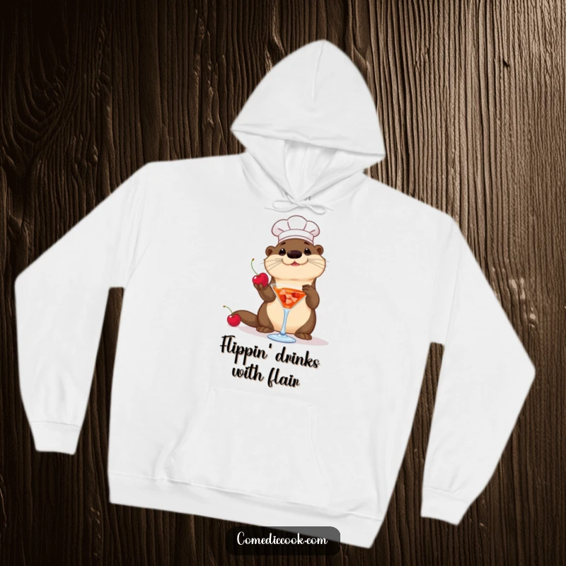 Funny Otter Chef Hoodie: A playful otter chef tosses a cherry into a cocktail, offering warm and humorous comfort.