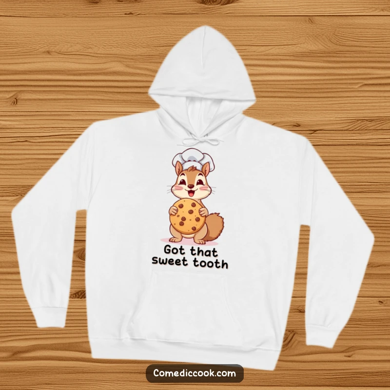 Funny Hoodie: a squirrel chef gleefully holds a giant cookie, radiating enthusiasm and nutty humor.